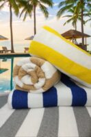 three beach towels with water in background